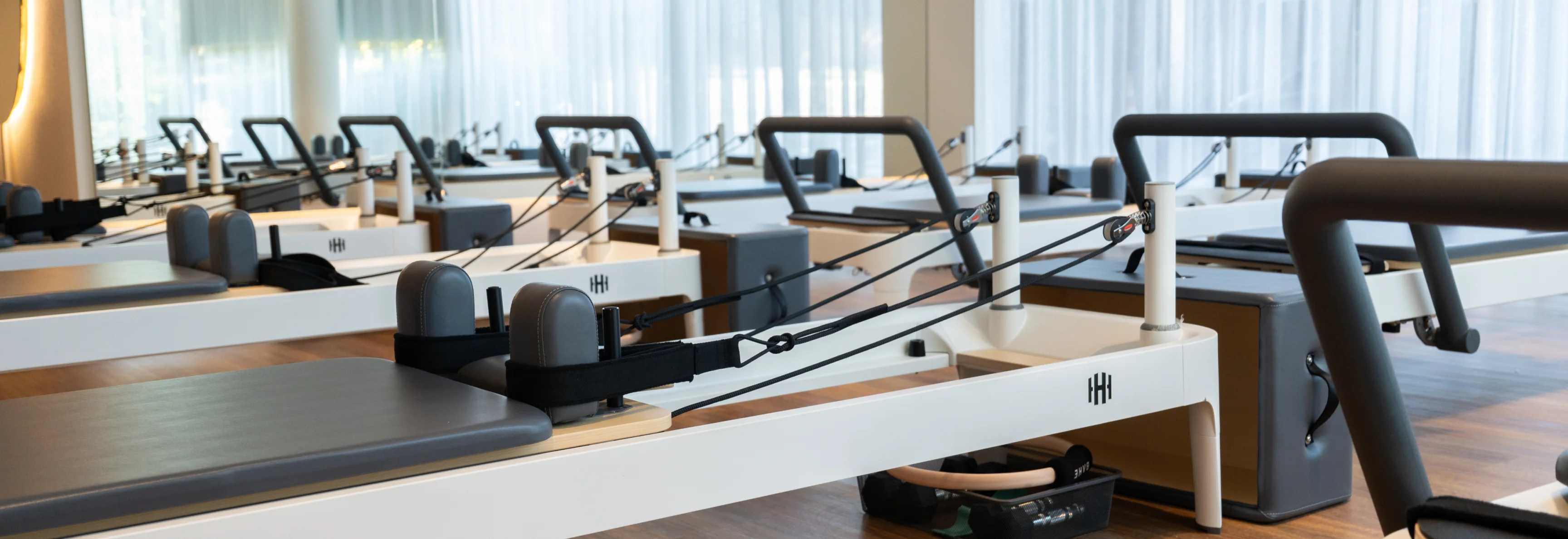 Housed Chatswood pilates studio facilities overview showing reformer pilates equipment, studio space, and modern reception area