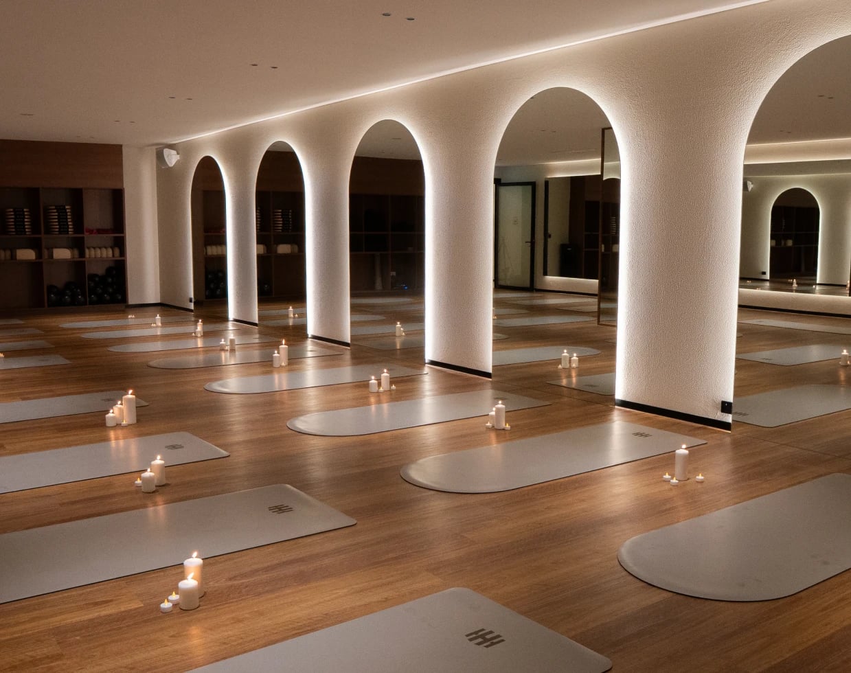 Housed Pilates mat studio featuring elegant arches and wooden flooring