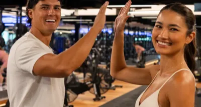Two friends high-fiving at Housed gym - refer a friend and get 2 weeks free